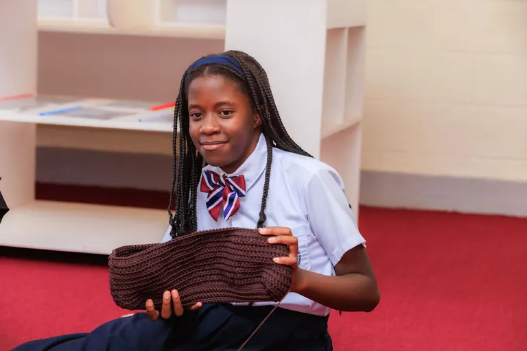 A learner sharing completed crochet work