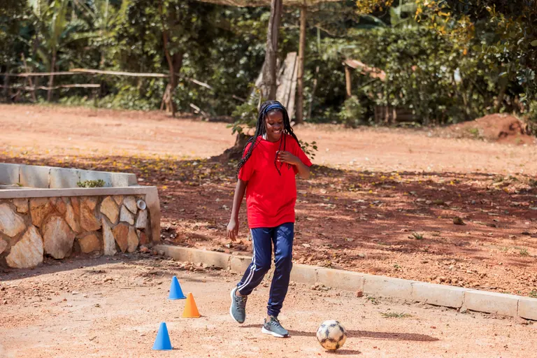 A learner practising football outdoors