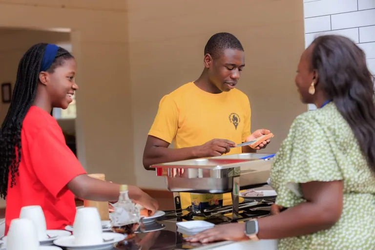 Learners and an adult at a food-service counter